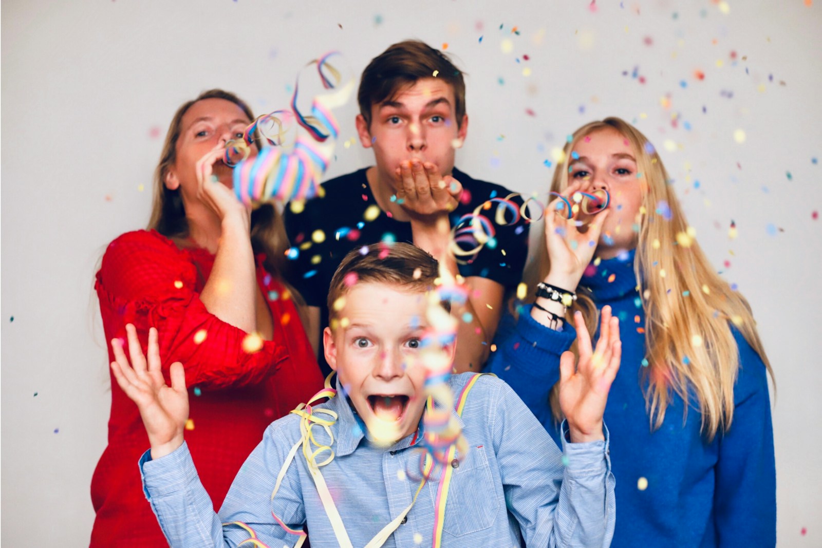 people blowing party favors